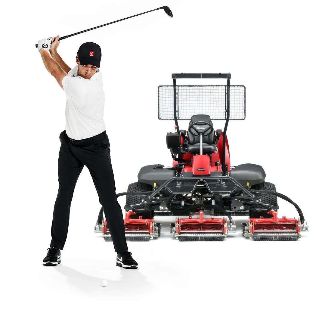 Golfer mid-swing beside a Baroness fairway mower